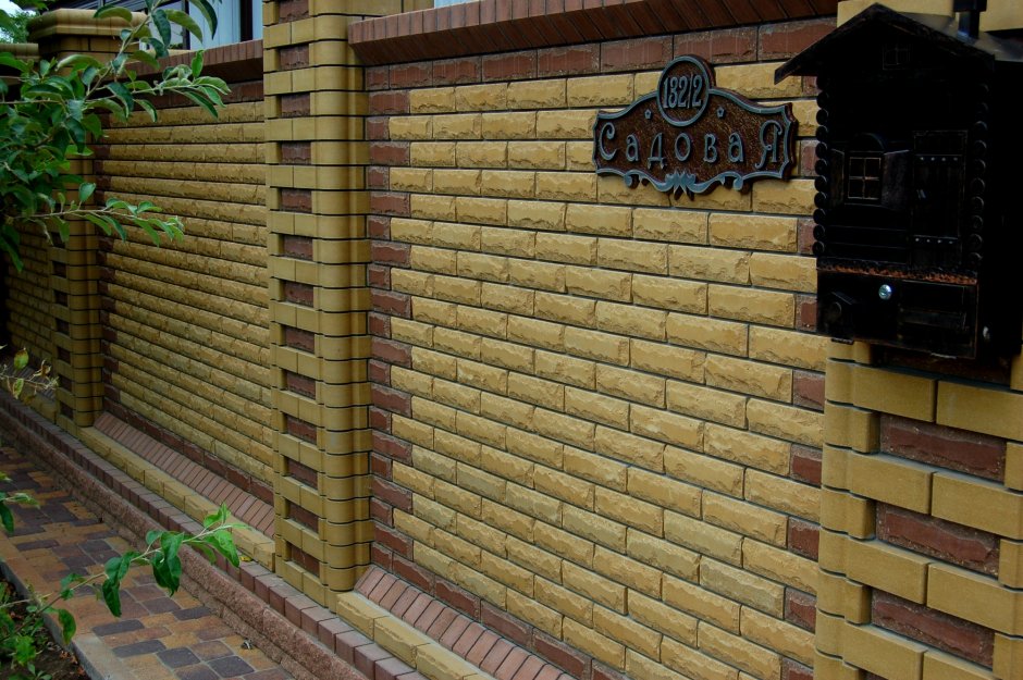 Забор из желтого и коричневого кирпича