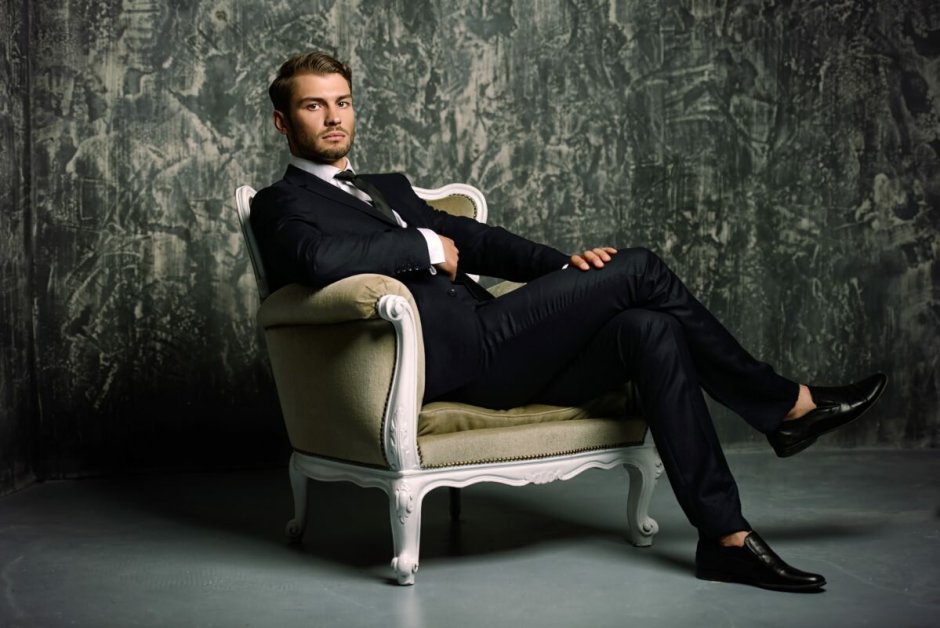 Мужчина в костюме сидит в кресле