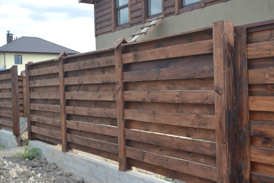 Горизонтальный деревянный забор на металлических Столбах