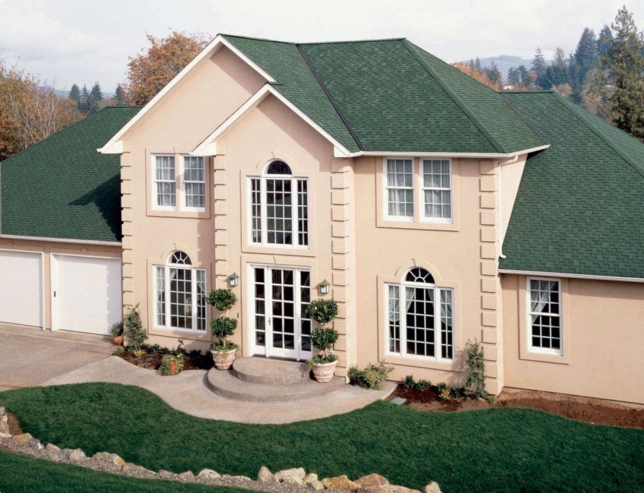 Дом из кирпича с зеленой крышей
